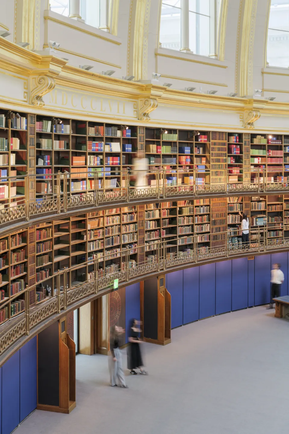 Round reading room entrance with 2 women walking into the space