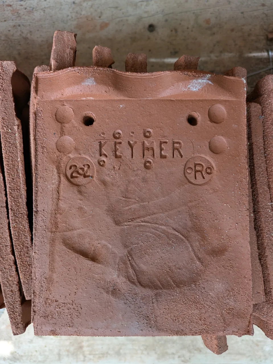 Keymer red clay tile with handprint of its maker stamped on